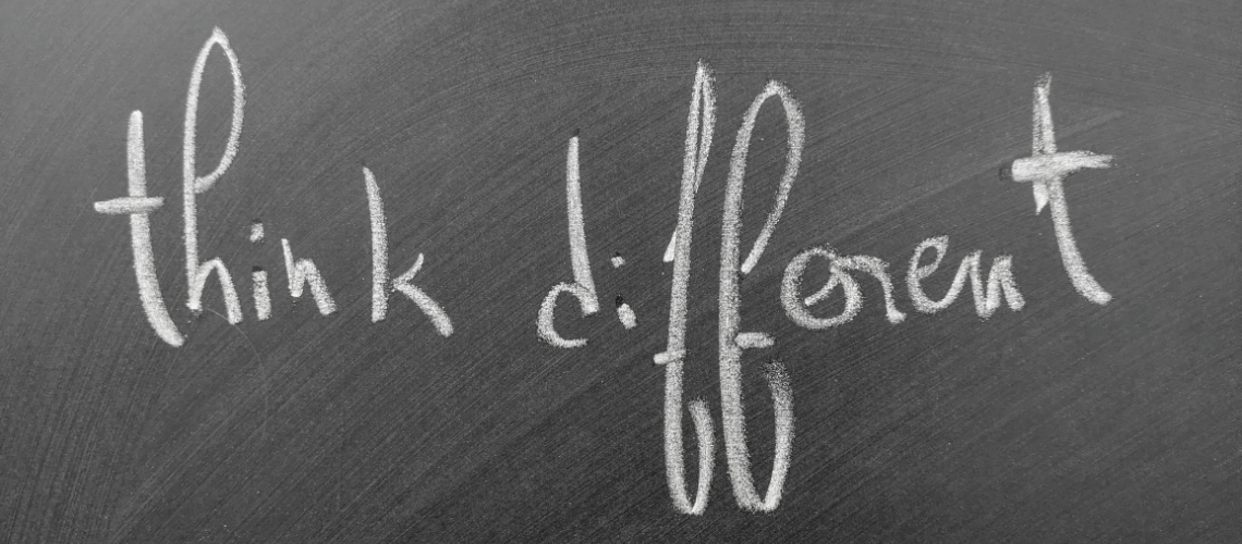 the words think different in chalk on a blackboard